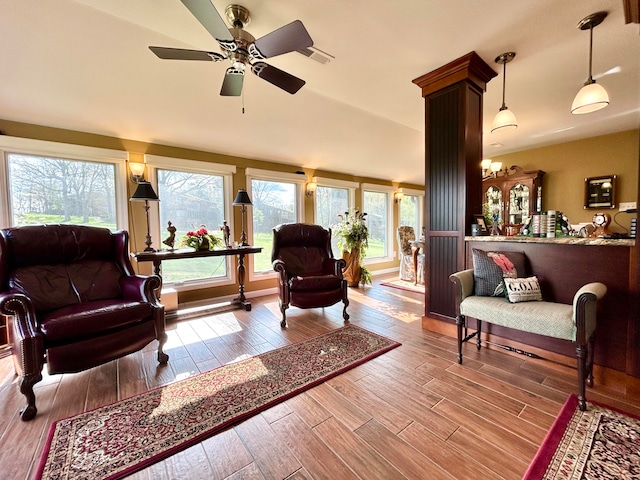 living room featuring plenty of natural light, ceiling fan, and light wood-type flooring