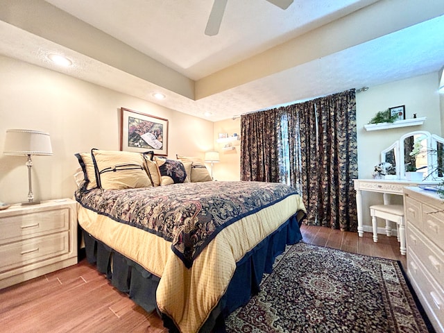 bedroom with ceiling fan and light wood-type flooring