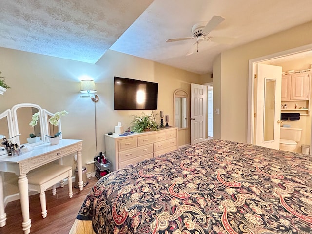 bedroom featuring ensuite bath, dark hardwood / wood-style floors, ceiling fan, and a textured ceiling