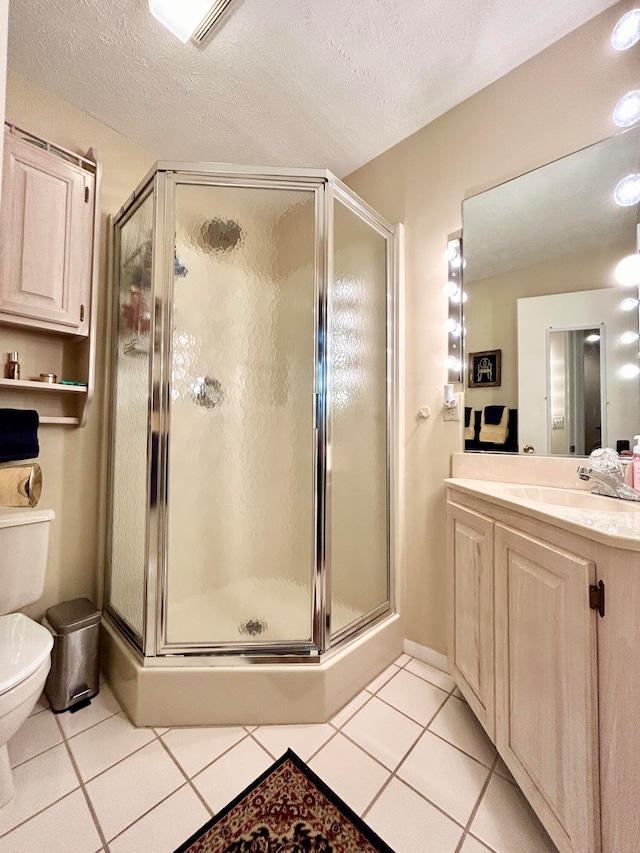 bathroom with a shower with door, toilet, a textured ceiling, vanity, and tile floors