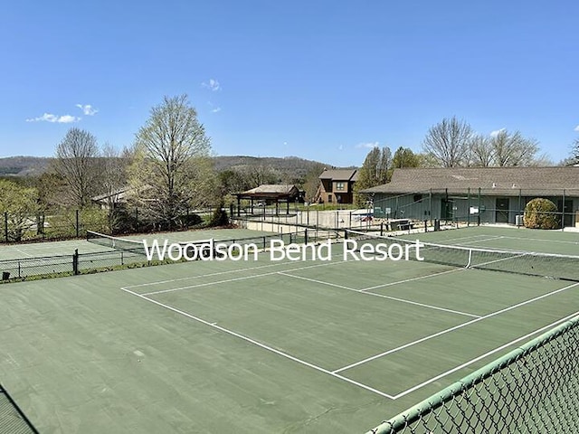 view of sport court with fence