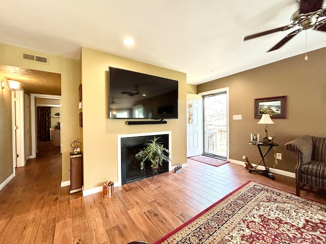 living room with ceiling fan and hardwood / wood-style flooring