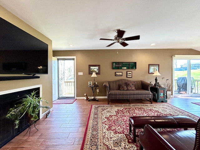 living room with ceiling fan and dark hardwood / wood-style flooring