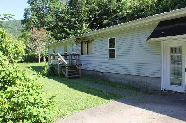 view of side of home with a lawn