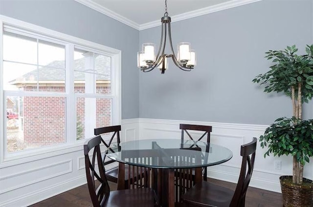 dining space with plenty of natural light, dark hardwood / wood-style flooring, a chandelier, and ornamental molding