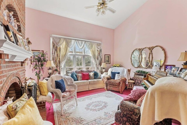 living room featuring ceiling fan, vaulted ceiling, brick wall, a fireplace, and hardwood / wood-style floors