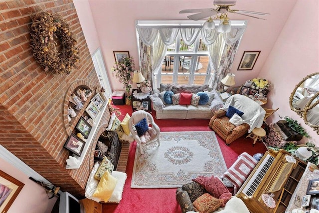 living room featuring ceiling fan, brick wall, and carpet flooring