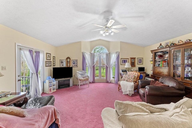 carpeted living room featuring vaulted ceiling, ceiling fan, and a textured ceiling