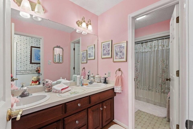 bathroom with tile flooring, a textured ceiling, and double sink vanity