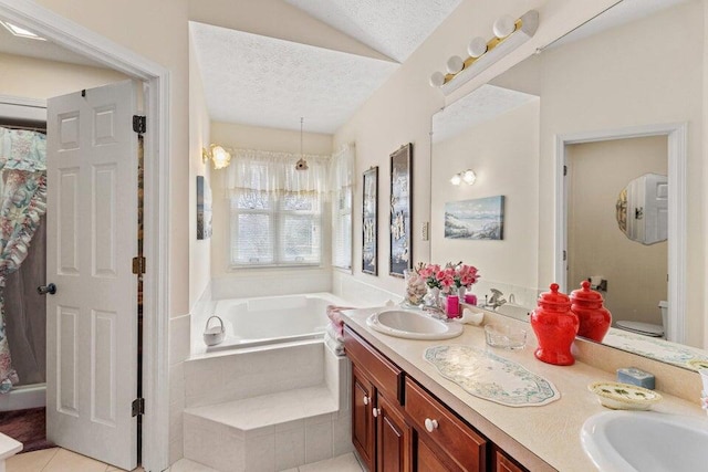 bathroom with tiled bath, a textured ceiling, large vanity, and dual sinks