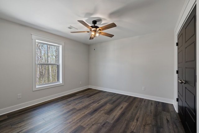 unfurnished room with dark hardwood / wood-style flooring and ceiling fan