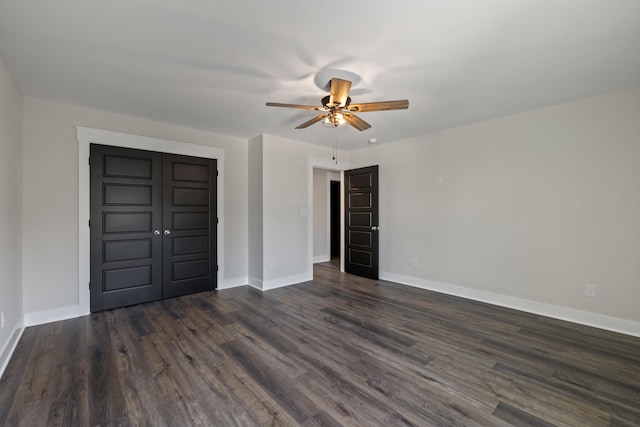 unfurnished bedroom featuring a closet, ceiling fan, and dark wood-type flooring