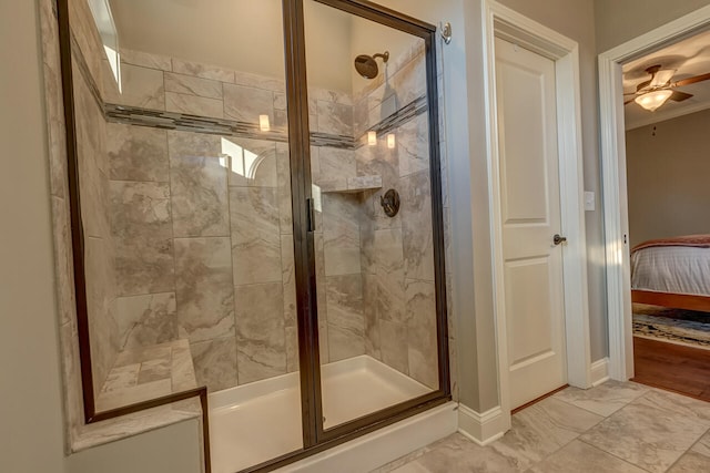 bathroom with ceiling fan, an enclosed shower, and hardwood / wood-style flooring