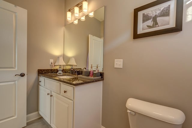 bathroom featuring toilet and large vanity