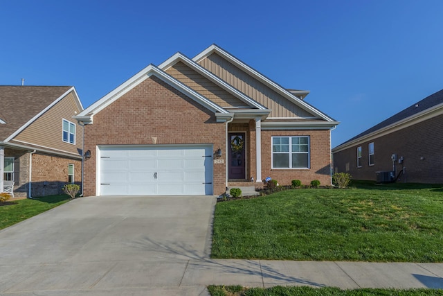 craftsman inspired home with a front lawn, a garage, and central AC unit