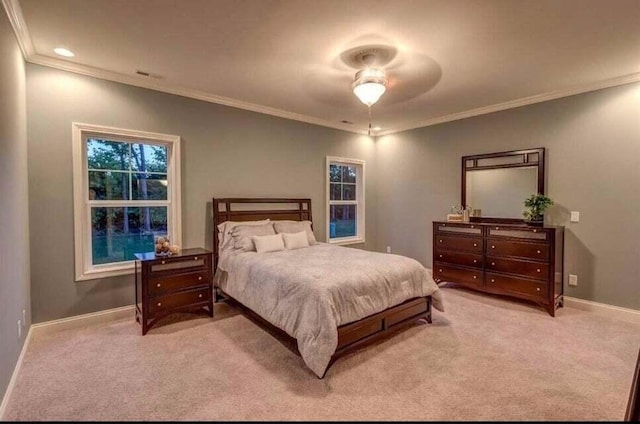 carpeted bedroom featuring ceiling fan and ornamental molding