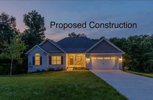 view of front of house with a garage and a yard