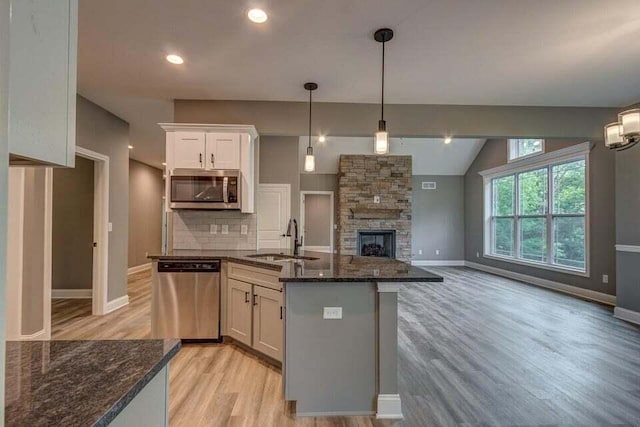 313 Old Station Rd, Frankfort, KY 40601 - kitchen with a sink, backsplash, appliances with stainless steel finishes, open floor plan, and white cabinets
