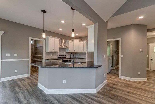 313 Old Station Rd, Frankfort, KY 40601 - kitchen with white cabinetry, baseboards, dark wood finished floors, a sink, and wall chimney exhaust hood