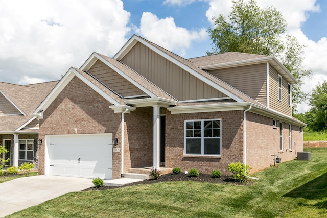 craftsman-style home featuring a garage, a front lawn, and central AC unit