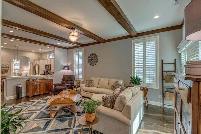 living room with dark wood-type flooring, a wealth of natural light, and beam ceiling