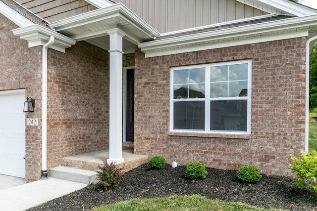 doorway to property featuring a garage