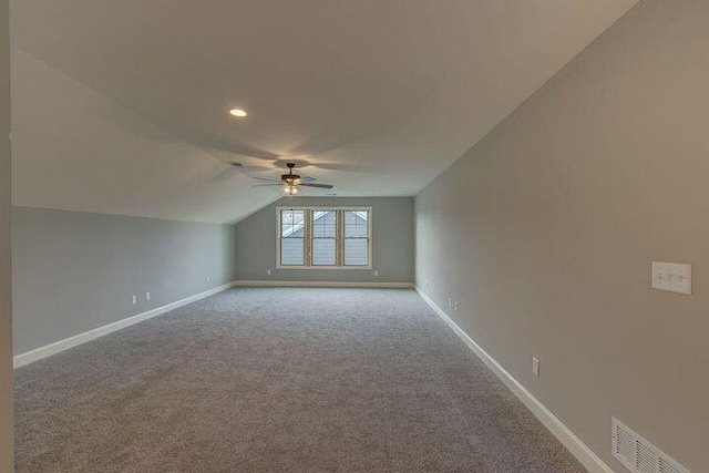 bonus room with light carpet, ceiling fan, and vaulted ceiling