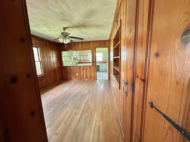 256 Carrick Pike, Georgetown, KY 40324 - spare room with plenty of natural light, light wood-style floors, wooden walls, a ceiling fan, and a textured ceiling