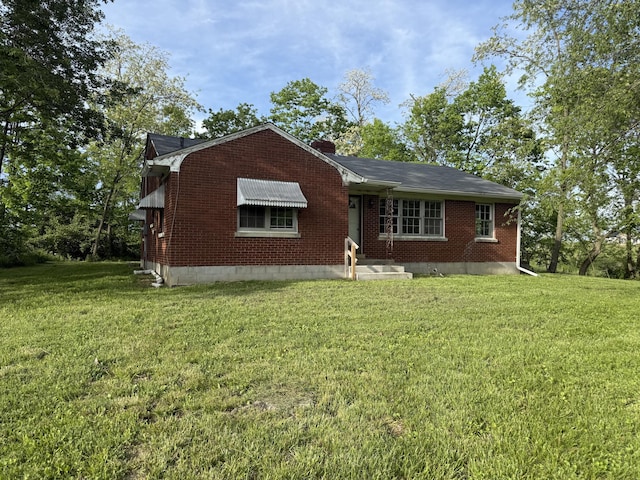 256 Carrick Pike, Georgetown, KY 40324 - view of front facade featuring a front yard, brick siding, and a chimney