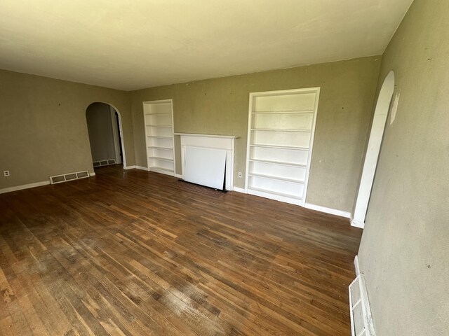 256 Carrick Pike, Georgetown, KY 40324 - unfurnished room with arched walkways, built in features, hardwood / wood-style flooring, and baseboards