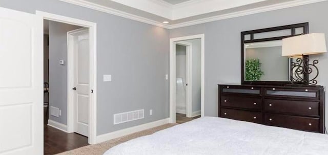 bedroom featuring crown molding and dark wood-type flooring