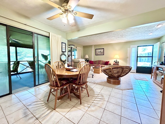 dining room featuring a textured ceiling, ceiling fan, and light tile floors