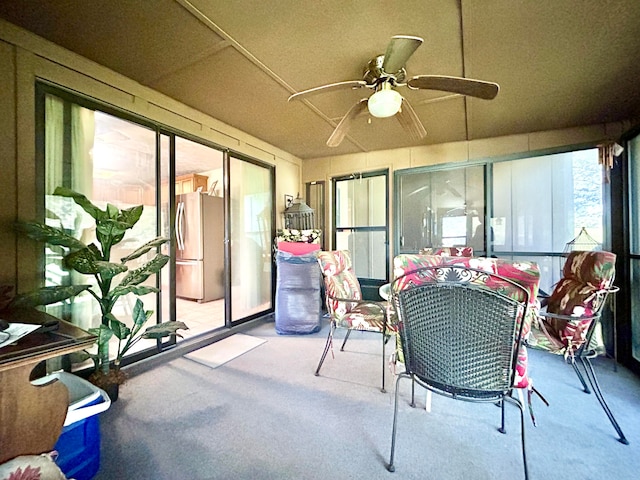 sunroom / solarium featuring ceiling fan