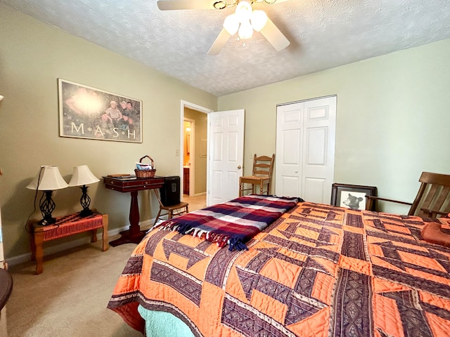 carpeted bedroom featuring a closet, a textured ceiling, and ceiling fan