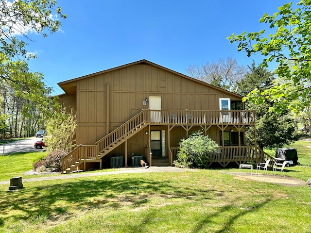 rear view of house with a yard and central air condition unit