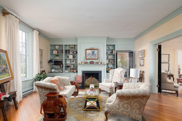 511 Boone Ave, Winchester, KY 40391 - living room featuring crown molding, light wood-type flooring, baseboard heating, and built in shelves