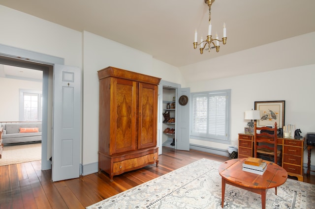 511 Boone Ave, Winchester, KY 40391 - living area with dark hardwood / wood-style floors, plenty of natural light, an inviting chandelier, and baseboard heating