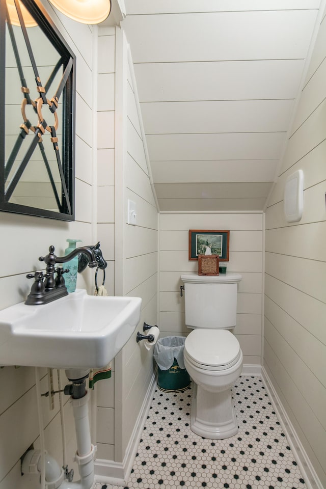 511 Boone Ave, Winchester, KY 40391 - bathroom with wood walls, vaulted ceiling, toilet, and tile flooring