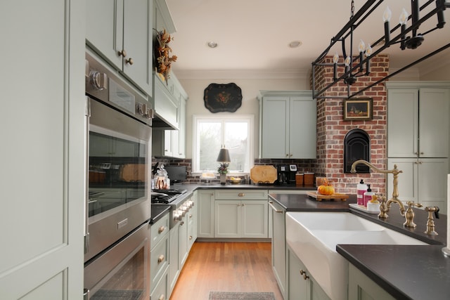 511 Boone Ave, Winchester, KY 40391 - kitchen with light hardwood / wood-style flooring, brick wall, tasteful backsplash, stainless steel oven, and ornamental molding
