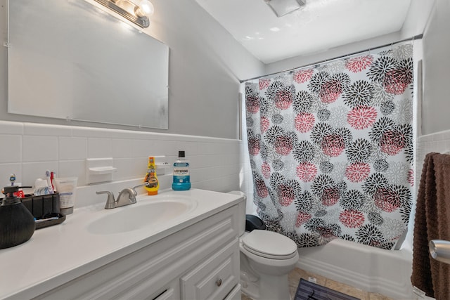 full bathroom with shower / tub combo with curtain, vanity, tile walls, and toilet