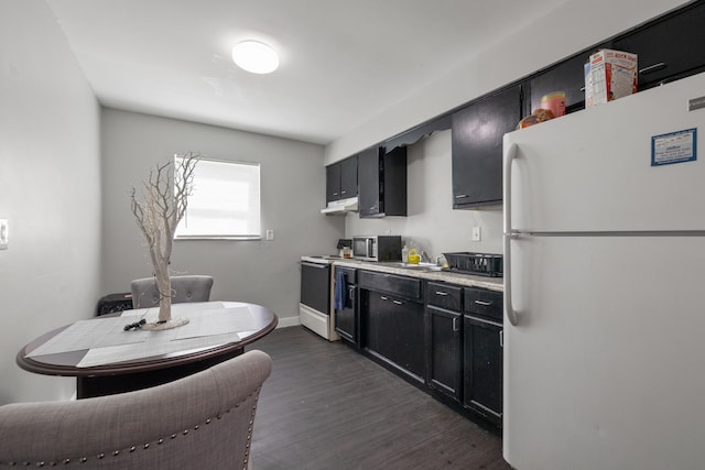 kitchen featuring white appliances and dark wood-type flooring