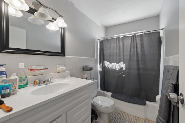 full bathroom featuring shower / tub combo, tile patterned floors, toilet, vanity, and tile walls