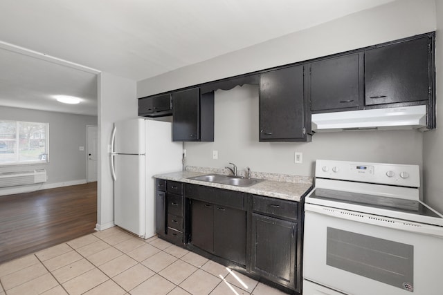 kitchen with sink, white appliances, and light hardwood / wood-style flooring