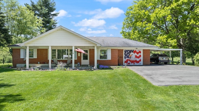 ranch-style home featuring a front lawn and a carport