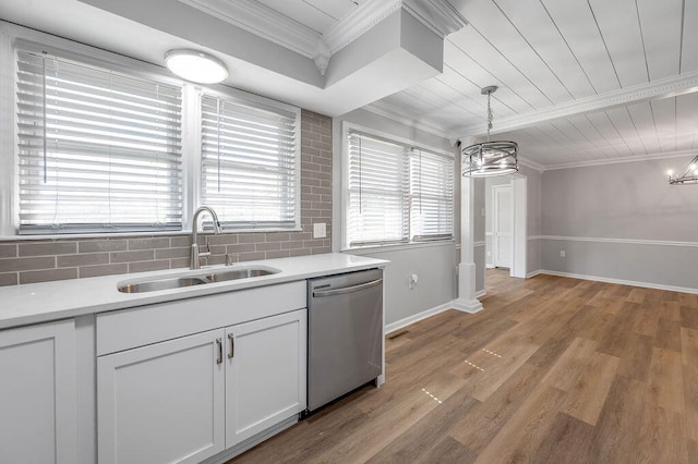 kitchen featuring decorative light fixtures, light hardwood / wood-style floors, dishwasher, and sink