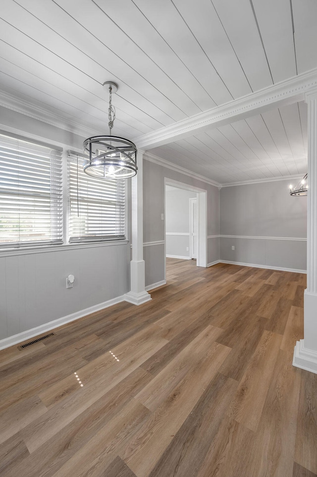 unfurnished living room with ornamental molding, wood ceiling, hardwood / wood-style floors, and a chandelier