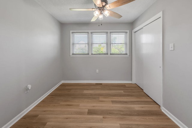 unfurnished room with ceiling fan and hardwood / wood-style floors