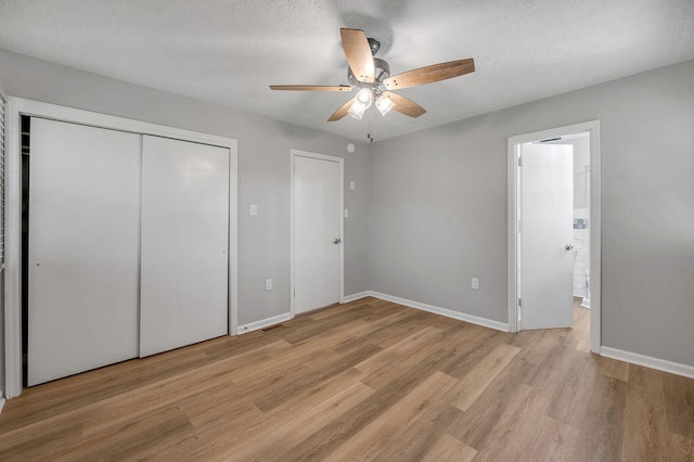 unfurnished bedroom with a closet, ceiling fan, and light wood-type flooring