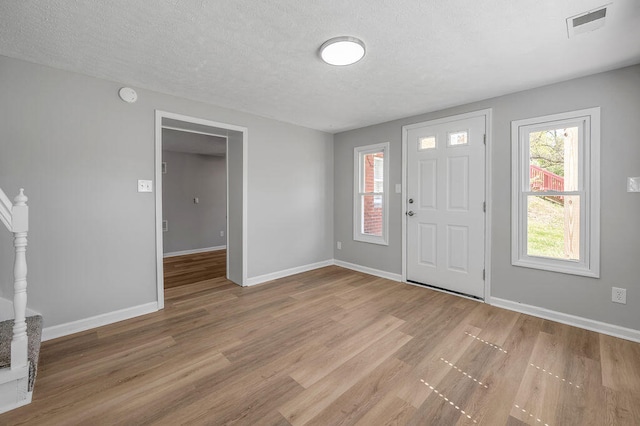 entrance foyer featuring a textured ceiling and hardwood / wood-style floors