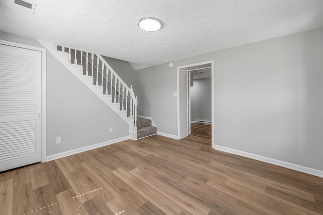 interior space featuring hardwood / wood-style floors and a baseboard heating unit